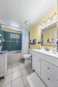 English Garden Bathroom with vanity and shower tub- Windemere Inn Florida bed and breakfast