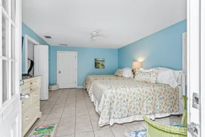 English Garden Bedroom blue and white suite with two beds and a ceiling fan - Windemere Inn Florida bed and breakfast