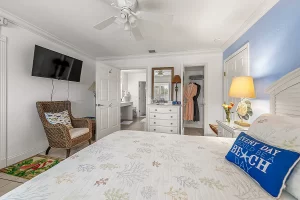 South Beach Bedroom blue and white suite with closet and wicker chair - Windemere Inn Florida bed and breakfast