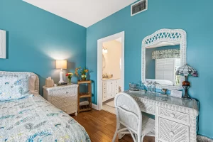 Summer Garden Bedroom blue and white suite with wicker desk and nightstand - Windemere Inn Florida bed and breakfast