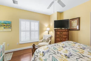 Windsong Bedroom chair, ceiling fan, and dresser - Windemere Inn Florida bed and breakfast