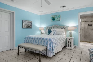 Wavecrest Bedroom blue and white suite with a ceiling fan and queen bed - Windemere Inn Florida bed and breakfast