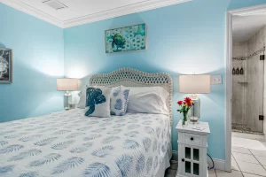 Wavecrest Bedroom blue and white suite with queen bed - Windemere Inn Florida bed and breakfast