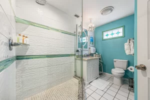 Windsong Bathroom blue and white bathroom vanity and tiled walk-in shower - Windemere Inn Florida bed and breakfast