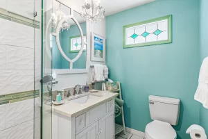 Windsong Bathroom blue and white bathroom vanity and small window - Windemere Inn Florida bed and breakfast