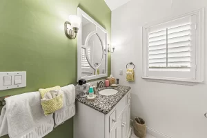 Forever Spring Bathroom green and white bathroom with a marbled granite vanity and window - Windemere Inn Florida bed and breakfast