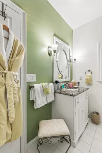 Forever Spring Bathroom green and white bathroom with a marbled granite vanity and robe - Windemere Inn Florida bed and breakfast