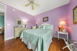 Forever Spring Bedroom pink and white suite with a queen bed and ceiling fan - Windemere Inn Florida bed and breakfast