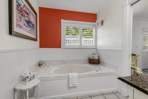 North Beach Bathroom with bathtub and window - Windemere Inn Florida bed and breakfast